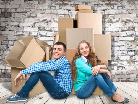 Crew separating cardboard, wood, and metal for recycling after a move