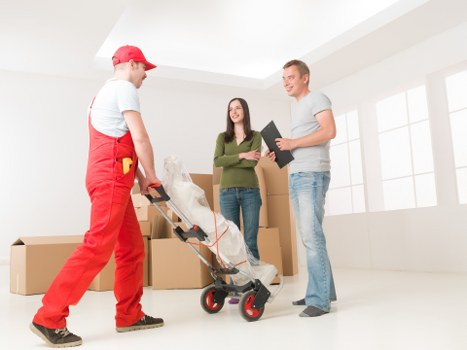 Professional movers handling furniture for a flat removal in Richmond