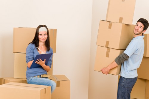 Staff handling moving boxes carefully during a removal service